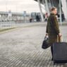 Traveler with luggage at an airport in autumn