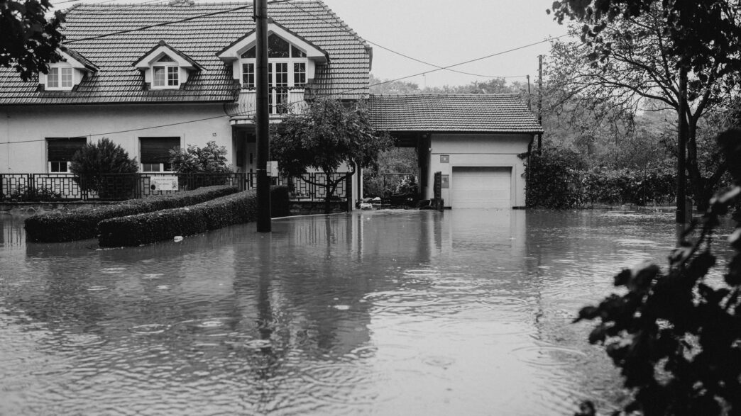 Floodwater covering a residential street outside homes