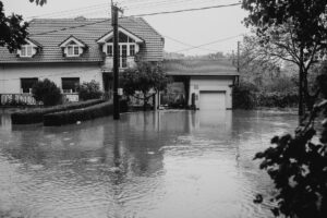 Floodwater covering a residential street outside homes