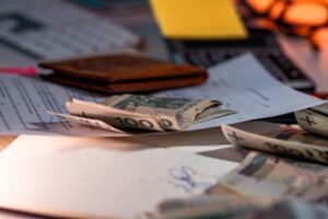 Calculator and payroll paperwork on a desk representing 401(k) contribution and employer match planning