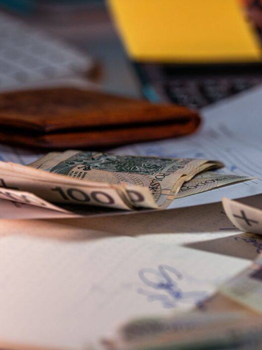 Calculator and payroll paperwork on a desk representing 401(k) contribution and employer match planning