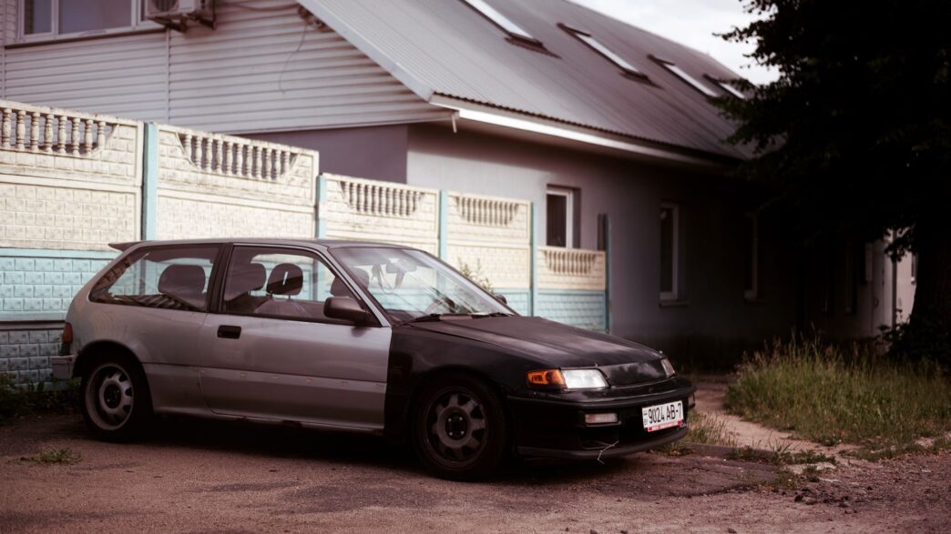 A single car parked in a suburban driveway after a household downsized to one vehicle