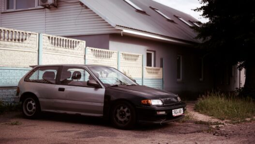 A single car parked in a suburban driveway after a household downsized to one vehicle