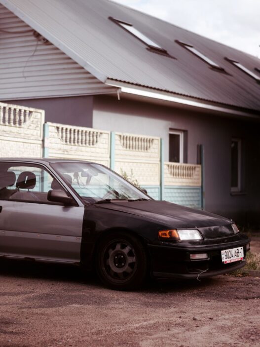 A single car parked in a suburban driveway after a household downsized to one vehicle