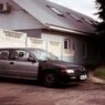 A single car parked in a suburban driveway after a household downsized to one vehicle