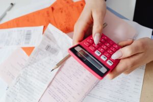 Medical bills and a calculator on a desk, used to review hospital bill financial assistance options