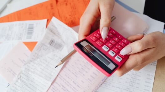 Medical bills and a calculator on a desk, used to review hospital bill financial assistance options
