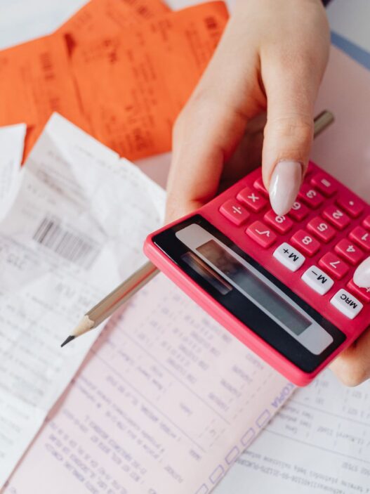 Medical bills and a calculator on a desk, used to review hospital bill financial assistance options