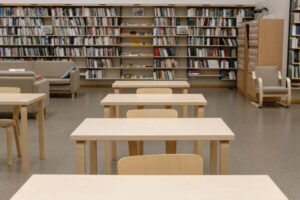 Rows of bookshelves in a public library reading room