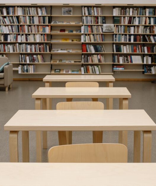 Rows of bookshelves in a public library reading room