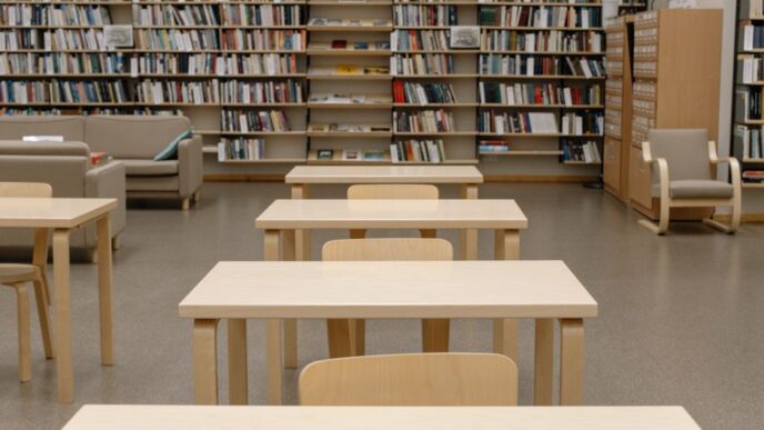 Rows of bookshelves in a public library reading room