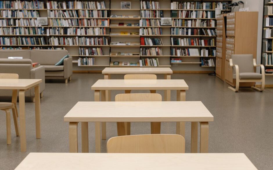 Rows of bookshelves in a public library reading room