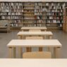 Rows of bookshelves in a public library reading room