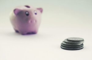 Savings jar and coins representing retirement savings benchmarks by age