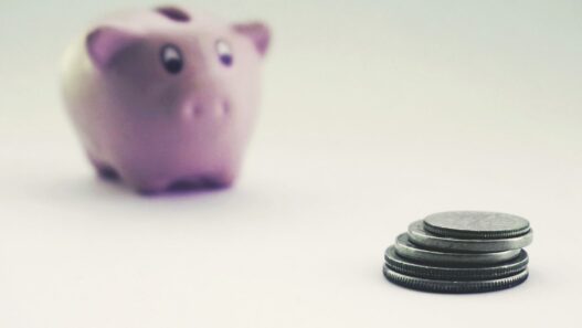 Savings jar and coins representing retirement savings benchmarks by age