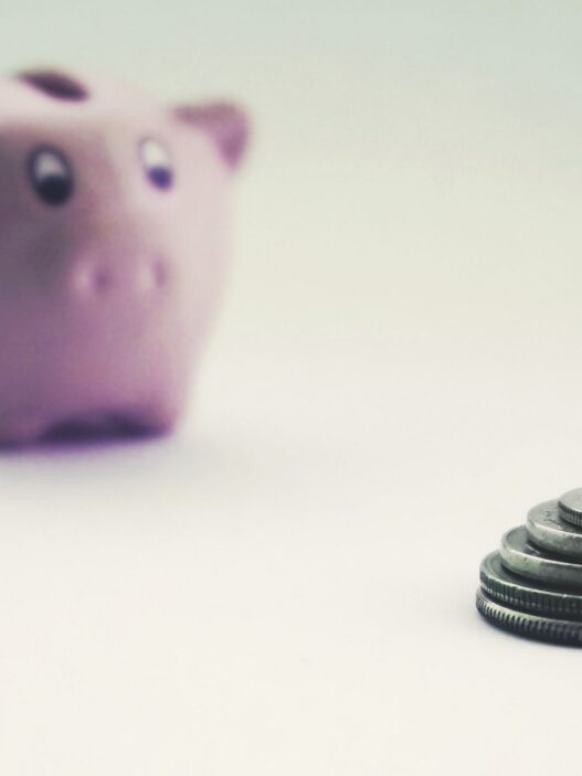 Savings jar and coins representing retirement savings benchmarks by age