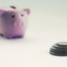 Savings jar and coins representing retirement savings benchmarks by age