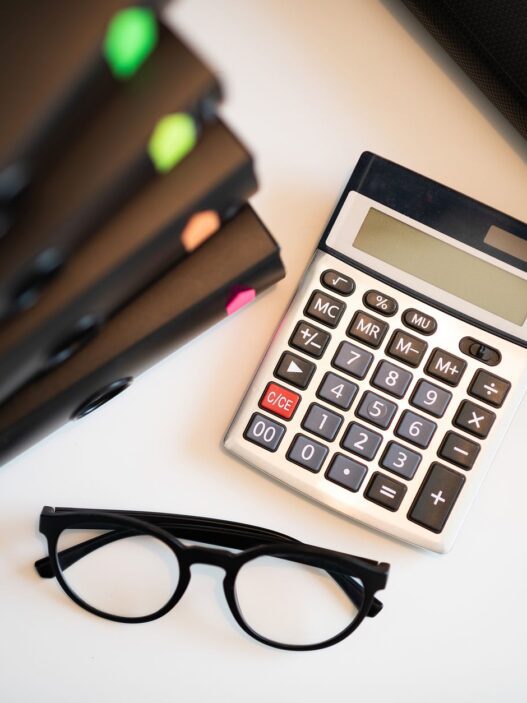 Student loan statement and calculator on a desk while planning a lower monthly payment