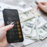 Person reviewing a cell phone bill on a smartphone