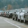 Rows of new vehicles on a car dealership lot during model-year clearance season
