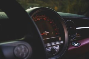 Car odometer and dashboard showing low mileage