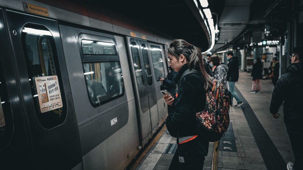Commuters boarding a train at a station, representing pre-tax commuter benefits