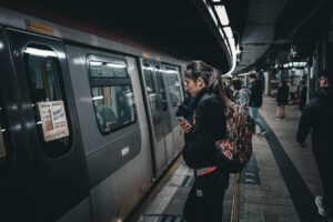 Commuters boarding a train at a station, representing pre-tax commuter benefits