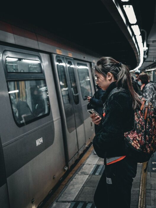 Commuters boarding a train at a station, representing pre-tax commuter benefits