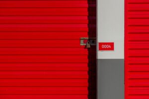 Row of orange self storage unit doors at a storage facility