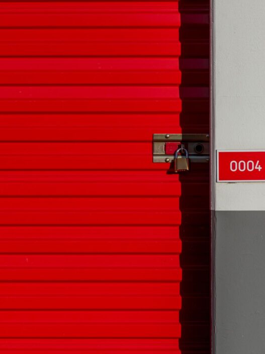 Row of orange self storage unit doors at a storage facility