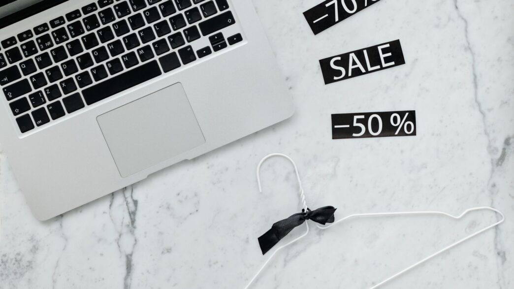 Shopper comparing online prices on a laptop and phone