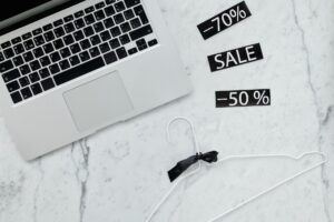 Shopper comparing online prices on a laptop and phone