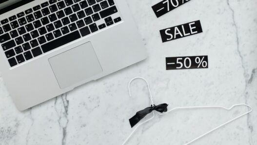 Shopper comparing online prices on a laptop and phone