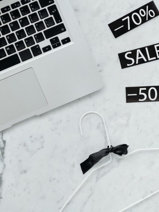 Shopper comparing online prices on a laptop and phone