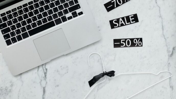 Shopper comparing online prices on a laptop and phone