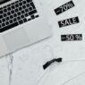 Shopper comparing online prices on a laptop and phone
