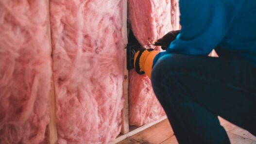 Attic insulation being installed to improve home energy efficiency