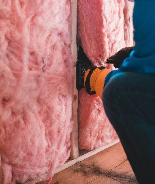 Attic insulation being installed to improve home energy efficiency