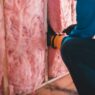 Attic insulation being installed to improve home energy efficiency