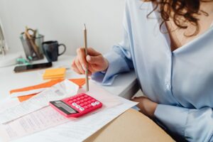 Household bills and a calculator on a desk during budget planning