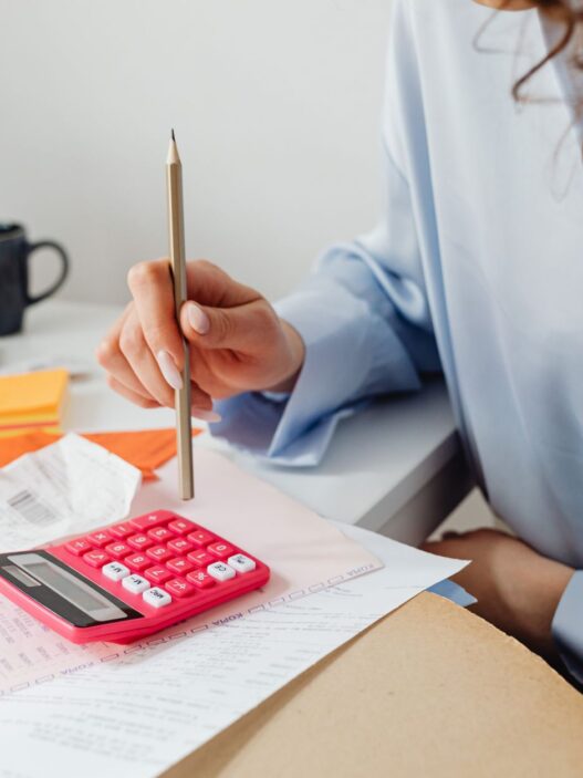 Household bills and a calculator on a desk during budget planning