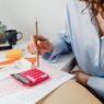 Household bills and a calculator on a desk during budget planning