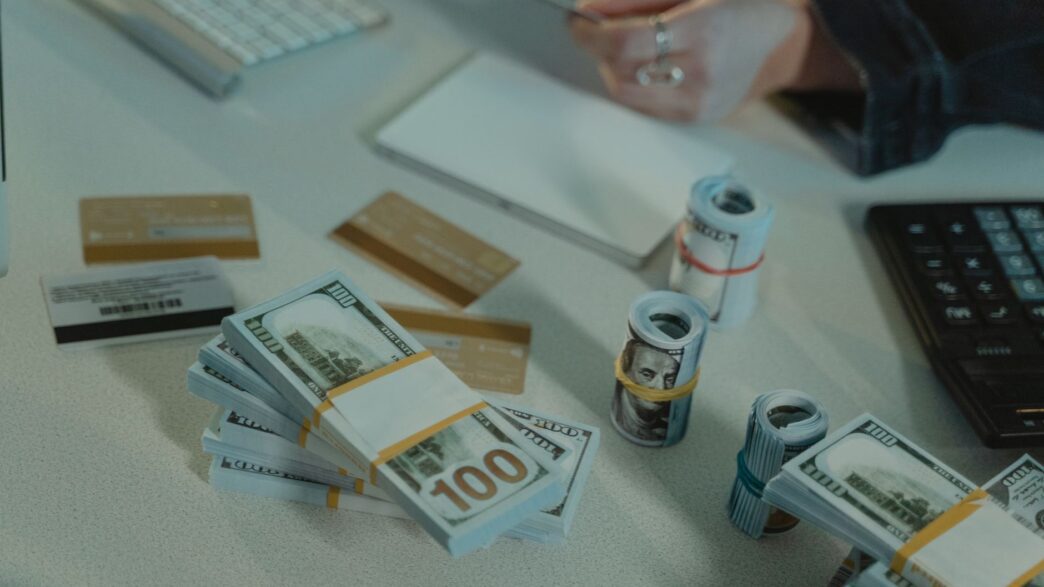 Credit card statements and a calculator on a desk while working out a balance transfer payoff