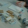 Credit card statements and a calculator on a desk while working out a balance transfer payoff
