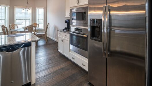 Row of new refrigerators and washing machines on display in an appliance showroom