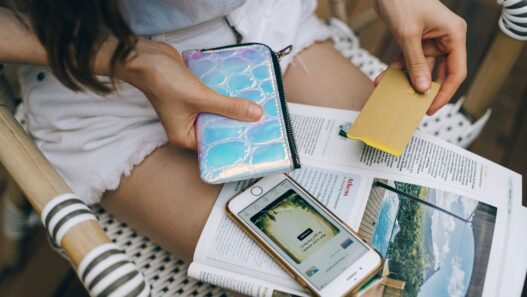 Credit cards and a smartphone on a table, used to check rewards balances