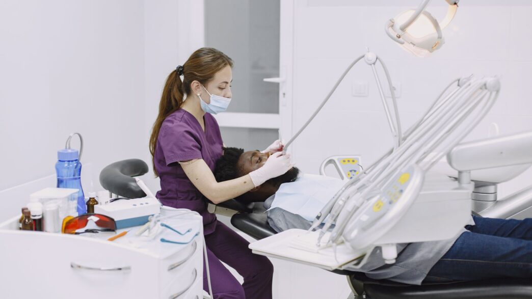 A patient in a dental chair during a checkup, illustrating dental insurance annual maximum planning