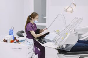 A patient in a dental chair during a checkup, illustrating dental insurance annual maximum planning