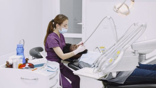 A patient in a dental chair during a checkup, illustrating dental insurance annual maximum planning