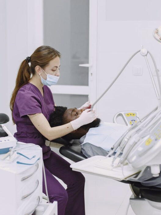 A patient in a dental chair during a checkup, illustrating dental insurance annual maximum planning